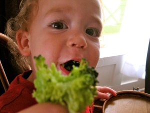 A kid truly happy to eat broccoli! 